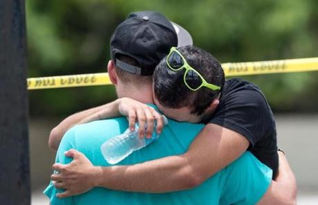 Supported by a friend, a man wept near the shooting scene.
